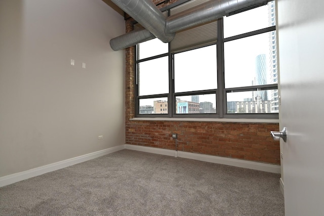 770 W Gladys Ave Unit 606, Chicago, IL 60661 - spare room with carpet floors, brick wall, and a city view