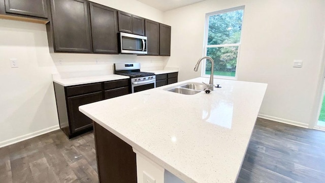 1813 Overland Dr, Plainfield, IL 60586 - kitchen featuring dark wood finished floors, appliances with stainless steel finishes, an island with sink, and dark brown cabinets
