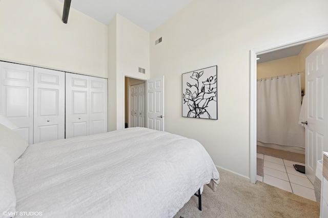 1907 N Milwaukee Ave Unit 307, Chicago, IL 60647 - bedroom with carpet flooring, a high ceiling, a closet, and tile patterned flooring