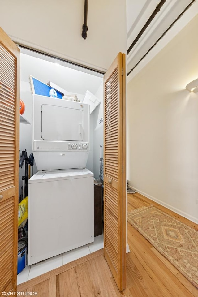 1907 N Milwaukee Ave Unit 307, Chicago, IL 60647 - washroom with stacked washing machine and dryer and wood finished floors