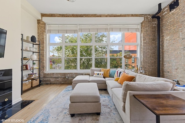 1907 N Milwaukee Ave Unit 307, Chicago, IL 60647 - living room featuring wood finished floors, plenty of natural light, and brick wall