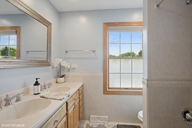 523 N Ela Rd, Barrington, IL 60010 - bathroom with tile walls, double vanity, a wainscoted wall, tile patterned flooring, and a shower