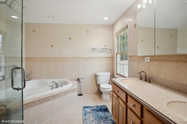 523 N Ela Rd, Barrington, IL 60010 - bathroom featuring tile walls, tile patterned flooring, double vanity, a bath, and a stall shower