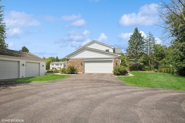 523 N Ela Rd, Barrington, IL 60010 - view of front of home with brick siding, a front yard, and a garage