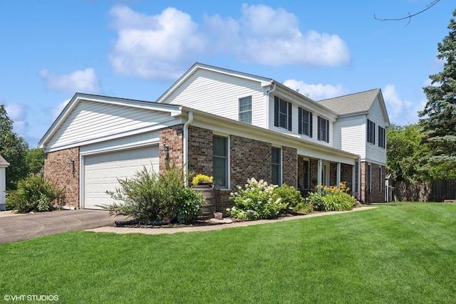 523 N Ela Rd, Barrington, IL 60010 - view of front facade featuring a garage, a front lawn, brick siding, and asphalt driveway