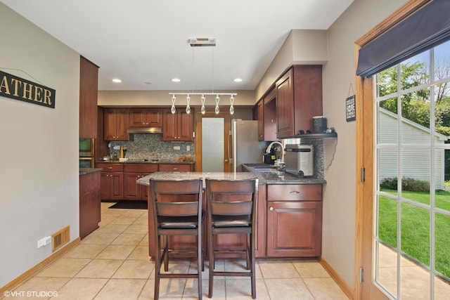 523 N Ela Rd, Barrington, IL 60010 - kitchen with decorative backsplash, light tile patterned flooring, a peninsula, dark stone countertops, and pendant lighting