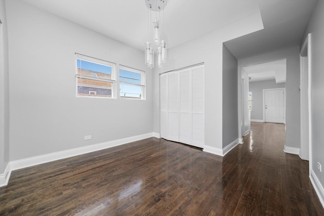 4426 S Artesian Ave, Chicago, IL 60632 - unfurnished bedroom with dark wood-type flooring, a closet, and a chandelier