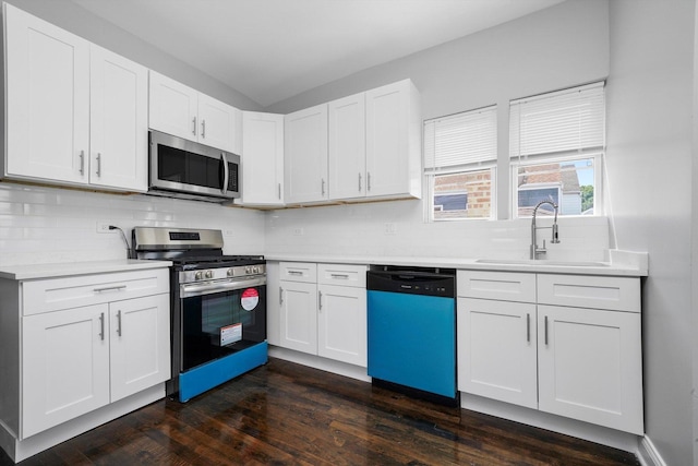 4426 S Artesian Ave, Chicago, IL 60632 - kitchen with appliances with stainless steel finishes, light countertops, backsplash, and white cabinetry
