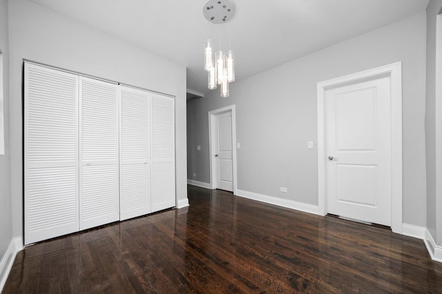 4426 S Artesian Ave, Chicago, IL 60632 - unfurnished bedroom with dark wood-style flooring, a closet, and a chandelier