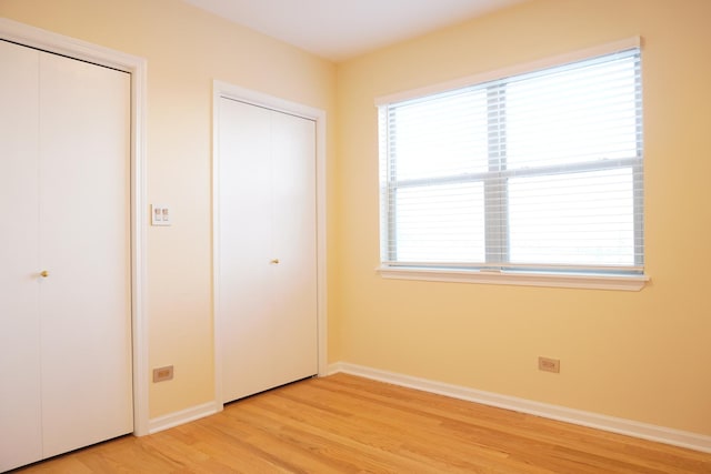 2665 W Warren Blvd Unit 3, Chicago, IL 60612 - unfurnished bedroom featuring light wood finished floors and multiple closets