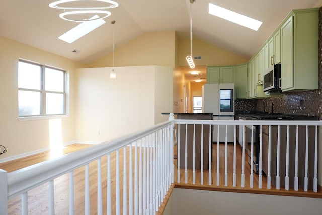 2665 W Warren Blvd Unit 3, Chicago, IL 60612 - kitchen with green cabinets, vaulted ceiling, a skylight, smart refrigerator, and tasteful backsplash