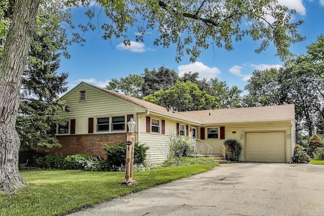 859 S Mount Prospect Rd, Des Plaines, IL 60016 - ranch-style house featuring a garage, brick siding, driveway, and a front yard