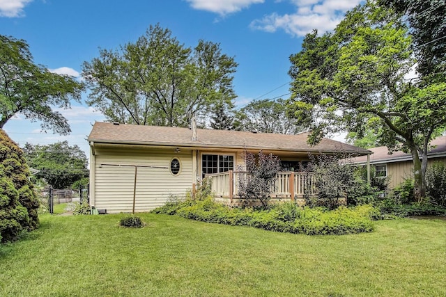 859 S Mount Prospect Rd, Des Plaines, IL 60016 - back of property featuring a lawn, a shingled roof, and a deck