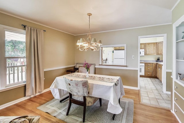 859 S Mount Prospect Rd, Des Plaines, IL 60016 - dining space with light wood-style flooring, a chandelier, and crown molding