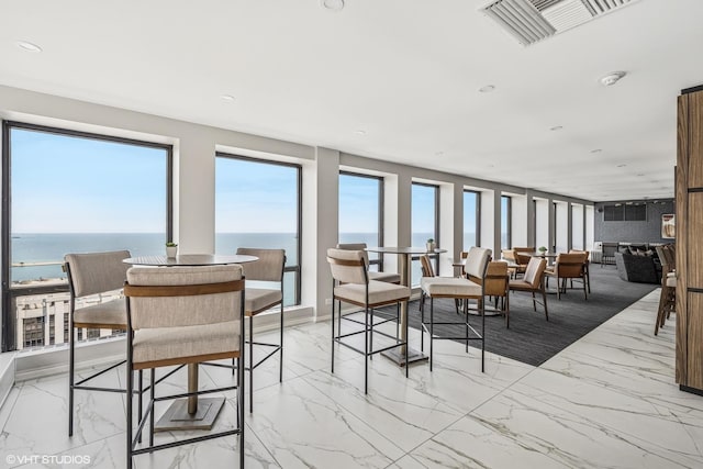 260 E Chestnut St Unit 1210, Chicago, IL 60611 - dining area featuring light marble finish flooring, a water view, and recessed lighting