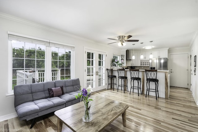2004 Pine Dr, Mchenry, IL 60051 - living area featuring french doors, a ceiling fan, ornamental molding, and light wood-style flooring