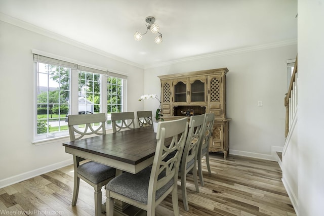 2004 Pine Dr, Mchenry, IL 60051 - dining area featuring a chandelier, healthy amount of natural light, light wood finished floors, and ornamental molding