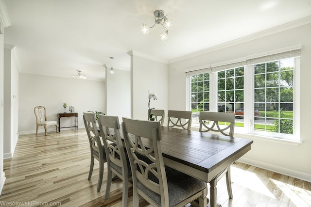 2004 Pine Dr, Mchenry, IL 60051 - dining space featuring crown molding, light wood-type flooring, and a chandelier