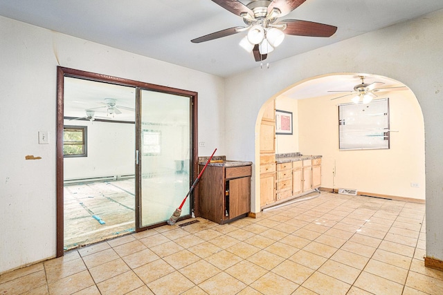 3038 225th St, Sauk Village, IL 60411 - spare room with a ceiling fan, arched walkways, and light tile patterned floors