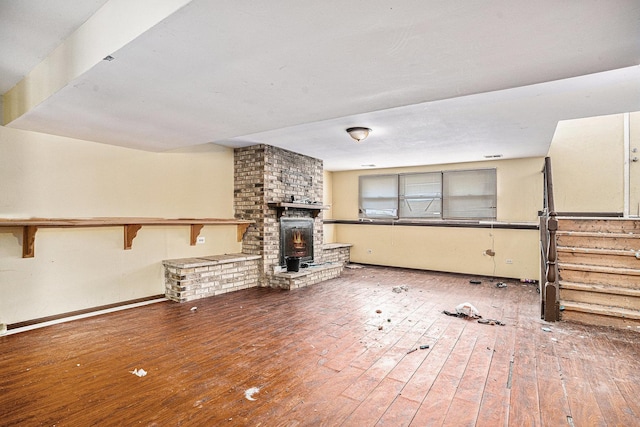 3038 225th St, Sauk Village, IL 60411 - unfurnished living room featuring hardwood / wood-style flooring and a brick fireplace