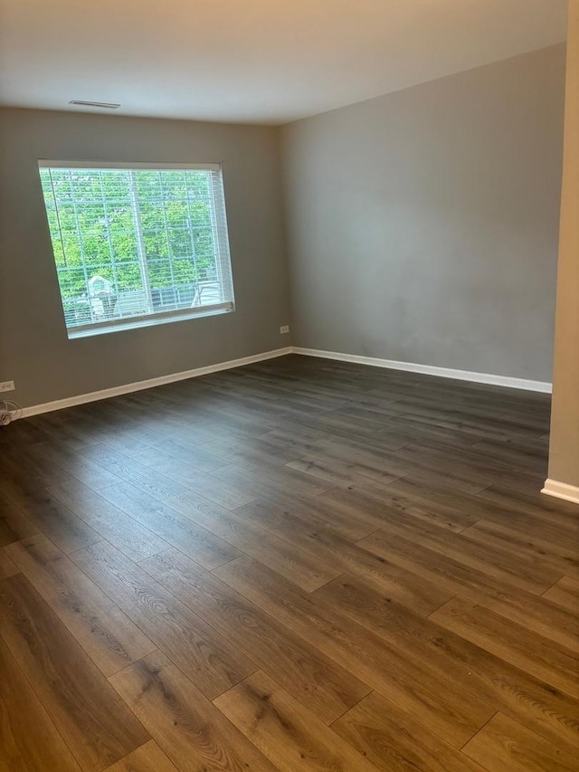 59 S Treehouse Ln S Unit 59, Round Lake, IL 60073 - empty room featuring dark wood-style flooring and baseboards