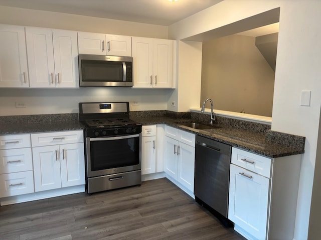 59 S Treehouse Ln S Unit 59, Round Lake, IL 60073 - kitchen featuring appliances with stainless steel finishes, white cabinets, dark stone countertops, and dark wood finished floors