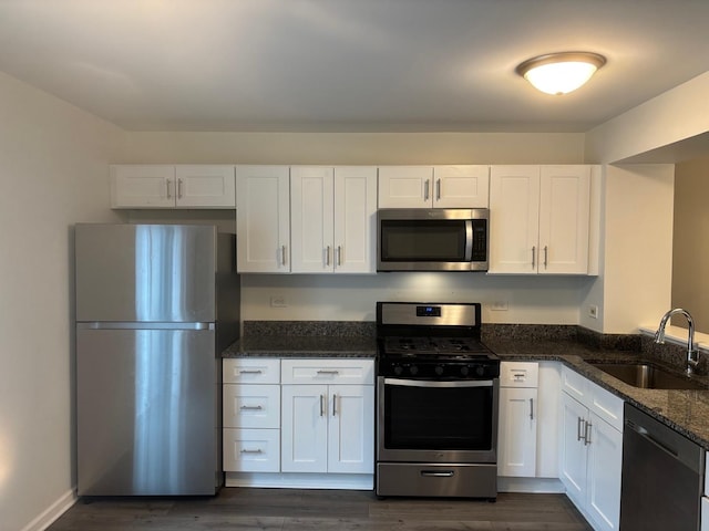 59 S Treehouse Ln S Unit 59, Round Lake, IL 60073 - kitchen with stainless steel appliances, white cabinetry, and dark stone countertops