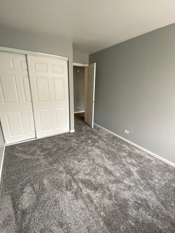 59 S Treehouse Ln S Unit 59, Round Lake, IL 60073 - unfurnished bedroom featuring carpet floors and a closet