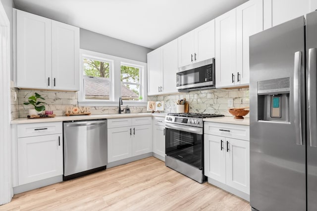 526 S Calumet Ave, Aurora, IL 60506 - kitchen featuring stainless steel appliances, light countertops, white cabinetry, and tasteful backsplash
