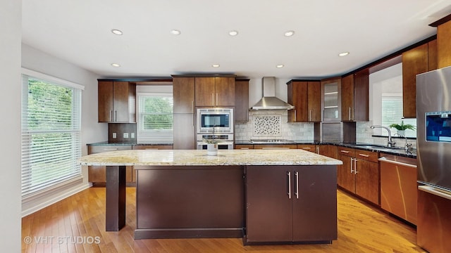 1291 White Chapel Ln, Algonquin, IL 60102 - kitchen featuring a kitchen island, stainless steel appliances, wall chimney exhaust hood, tasteful backsplash, and light wood-style floors