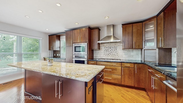 1291 White Chapel Ln, Algonquin, IL 60102 - kitchen with wall chimney range hood, light wood-style flooring, light stone countertops, tasteful backsplash, and recessed lighting