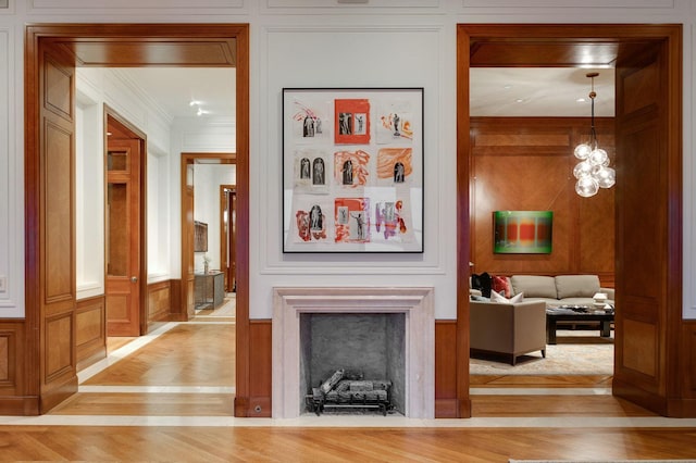 189 E Lake Shore Dr Unit Ph18, Chicago, IL 60611 - living room featuring a decorative wall, light wood finished floors, crown molding, a fireplace, and wooden walls
