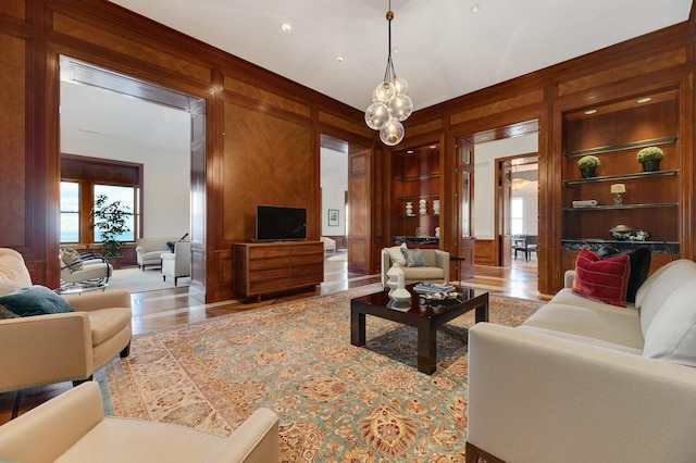 189 E Lake Shore Dr Unit Ph18, Chicago, IL 60611 - living room with plenty of natural light, built in features, wood finished floors, wood walls, and ornamental molding