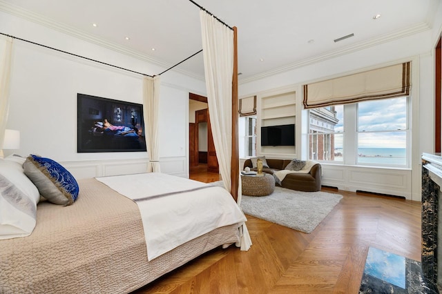 189 E Lake Shore Dr Unit Ph18, Chicago, IL 60611 - bedroom with crown molding, a decorative wall, and wainscoting