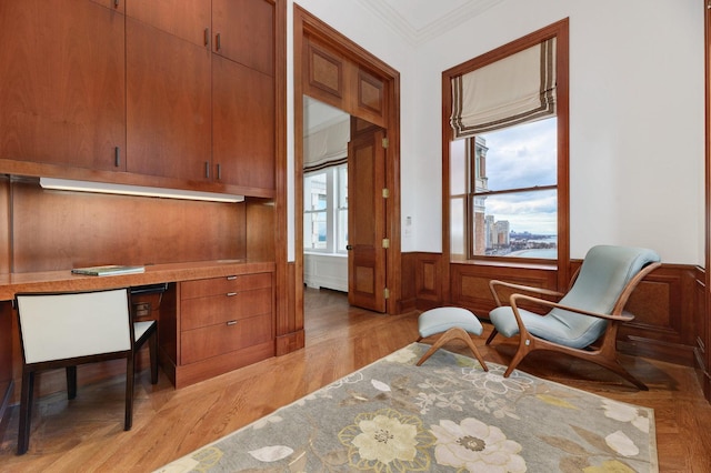 189 E Lake Shore Dr Unit Ph18, Chicago, IL 60611 - office area with ornamental molding, light wood-style floors, wainscoting, and built in desk