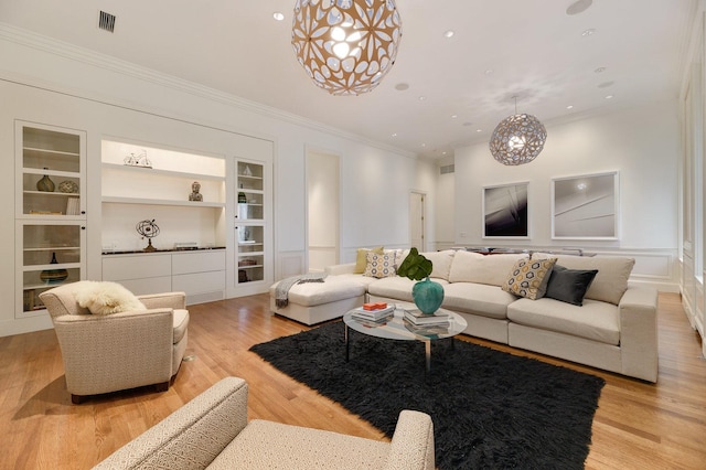 189 E Lake Shore Dr Unit Ph18, Chicago, IL 60611 - living room featuring built in features, ornamental molding, light wood-type flooring, recessed lighting, and a chandelier