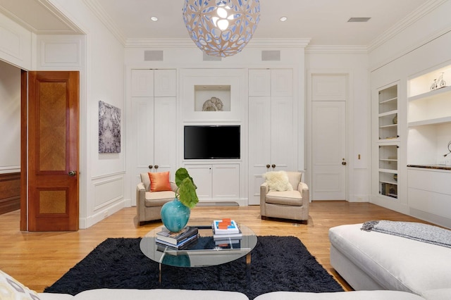 189 E Lake Shore Dr Unit Ph18, Chicago, IL 60611 - living area featuring built in shelves, light wood-type flooring, crown molding, a chandelier, and recessed lighting