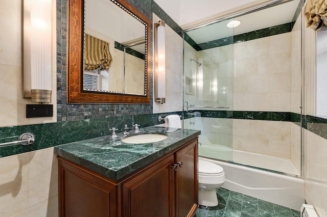 189 E Lake Shore Dr Unit Ph18, Chicago, IL 60611 - full bathroom featuring tile walls, vanity, combined bath / shower with glass door, and baseboard heating