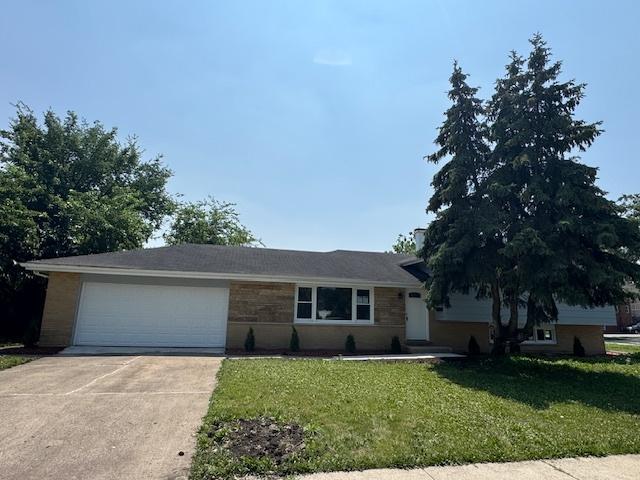 535 Florian Dr, Des Plaines, IL 60016 - view of front facade with concrete driveway, a front yard, and an attached garage
