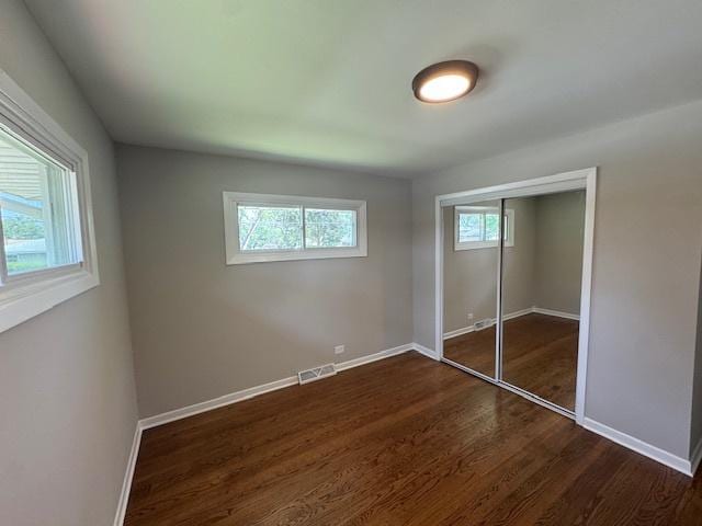 535 Florian Dr, Des Plaines, IL 60016 - unfurnished bedroom featuring dark wood-type flooring and a closet