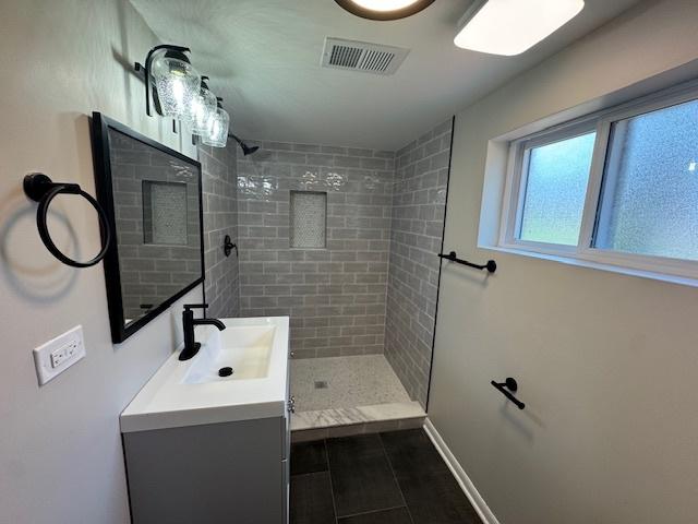 535 Florian Dr, Des Plaines, IL 60016 - full bath with a tile shower, vanity, and tile patterned floors