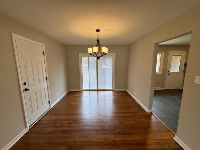 535 Florian Dr, Des Plaines, IL 60016 - unfurnished dining area with a chandelier, healthy amount of natural light, and dark wood-style flooring
