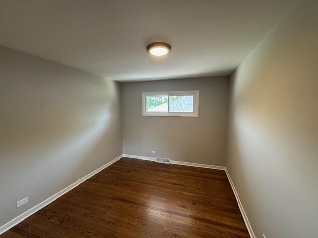 535 Florian Dr, Des Plaines, IL 60016 - unfurnished room with baseboards and dark wood-style flooring