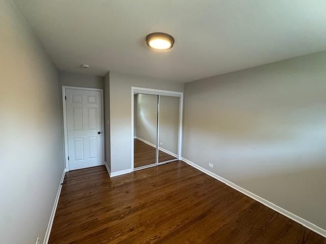 535 Florian Dr, Des Plaines, IL 60016 - unfurnished bedroom featuring dark wood-type flooring and a closet