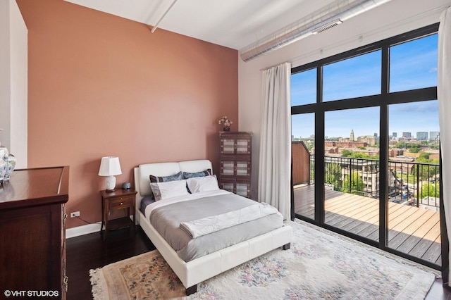 1524 S Sangamon St Unit 802, Chicago, IL 60608 - bedroom featuring access to exterior, wood finished floors, and a city view