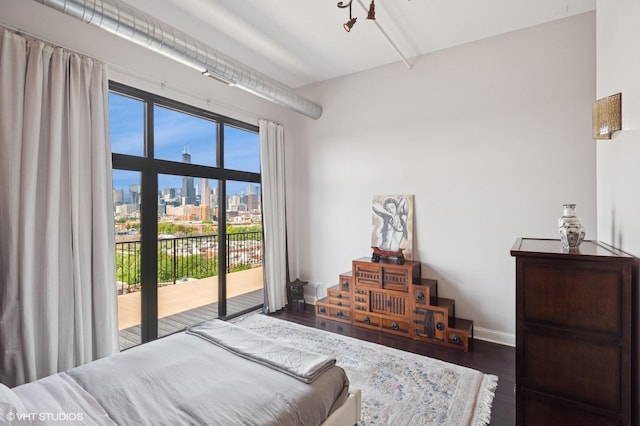 1524 S Sangamon St Unit 802, Chicago, IL 60608 - bedroom featuring access to outside, a skyline view, and wood finished floors