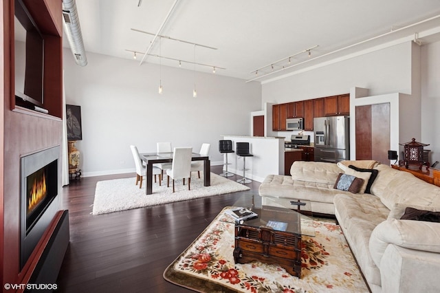 1524 S Sangamon St Unit 802, Chicago, IL 60608 - living area with dark wood-style floors, a lit fireplace, and track lighting