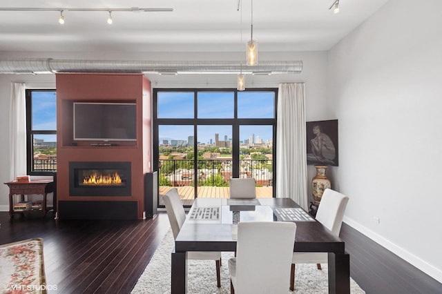 1524 S Sangamon St Unit 802, Chicago, IL 60608 - dining room with track lighting, a glass covered fireplace, healthy amount of natural light, and dark wood-style floors