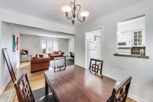 1555 Monroe Ave Unit 2, River Forest, IL 60305 - dining area featuring light wood-style flooring, a chandelier, a baseboard heating unit, and baseboard heating