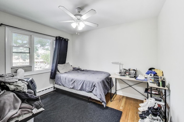 1555 Monroe Ave Unit 2, River Forest, IL 60305 - bedroom featuring a baseboard radiator, wood finished floors, and ceiling fan